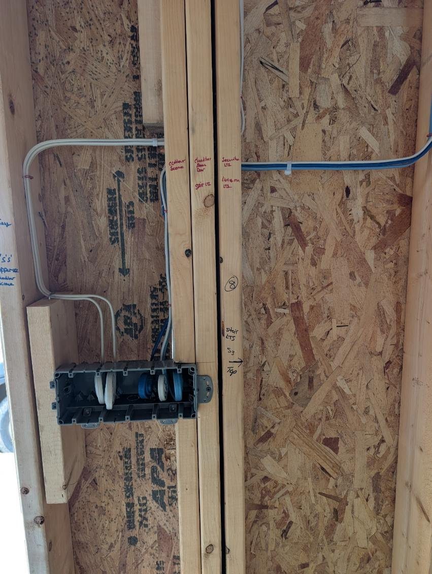 Rough-in wiring run and labeled at a switch box by VECA